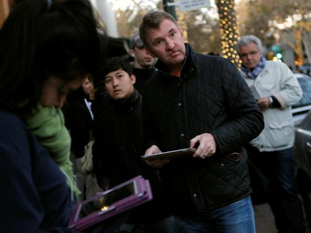 Customers wait in line for the initial sales of the iPad mini at Apple's retail store in Palo...