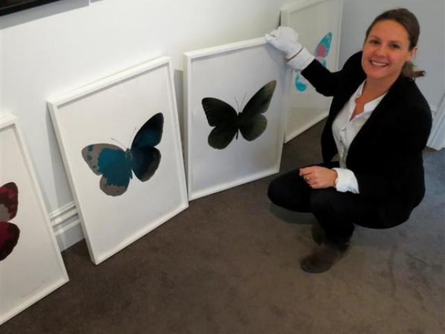 Gallery owner Nadene Milne, of Arrowtown, with limited edition prints by  Damien Hirst. Photo by...