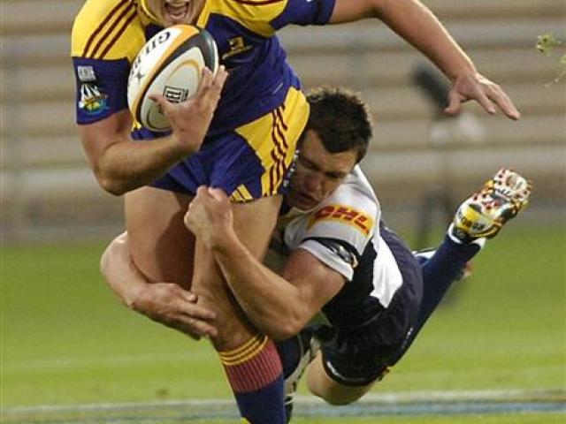 Impressive young fullback Israel Dagg is dragged down by Brumbies back Adam Ashley-Cooper at...