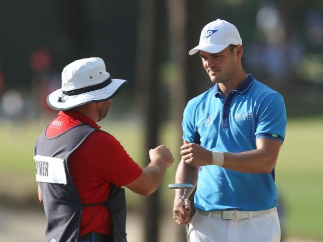 Martin Kaymer (right) celebrates with caddie Craig Connolly after making a putt on the 17th hole....