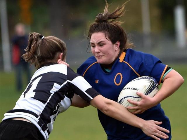 Otago Spirit hooker Tegan Hollows fends Hawkes Bay winger Felicity Powdrell at the University...