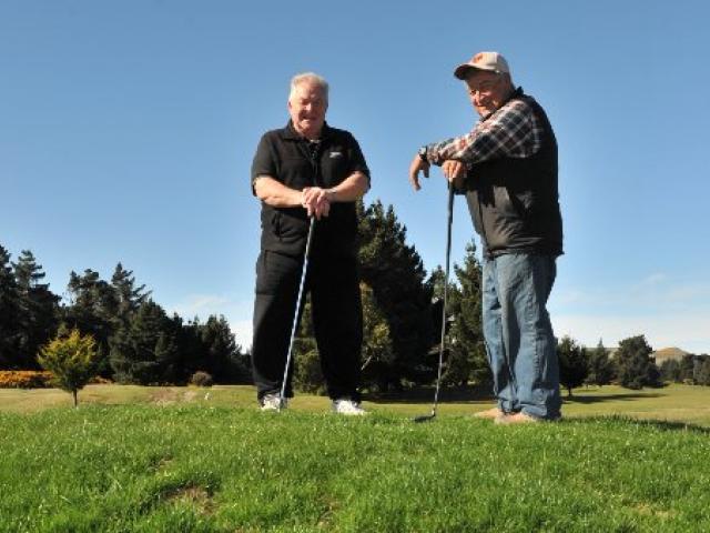 Otakou Golf Course president Alex MacGillivray and club member Kevin Charles stand on a swale of...
