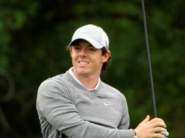 Rory McIlroy watches the path of his tee shot on the 3rd hole during the first round in the Honda...