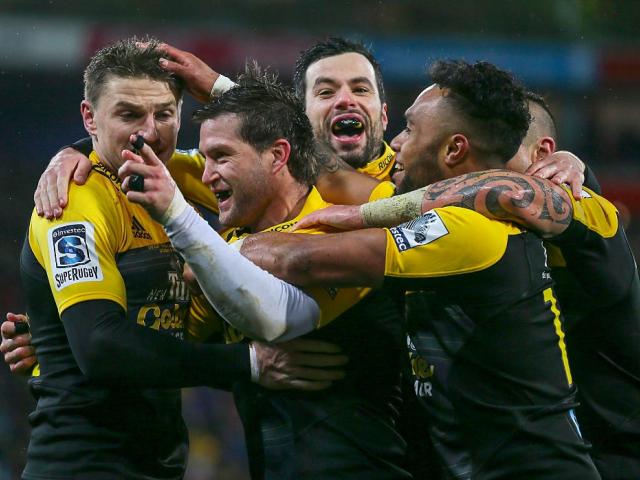 Cory Jane celebrates his try with Hurricanes' team mates. Photo: Reuters