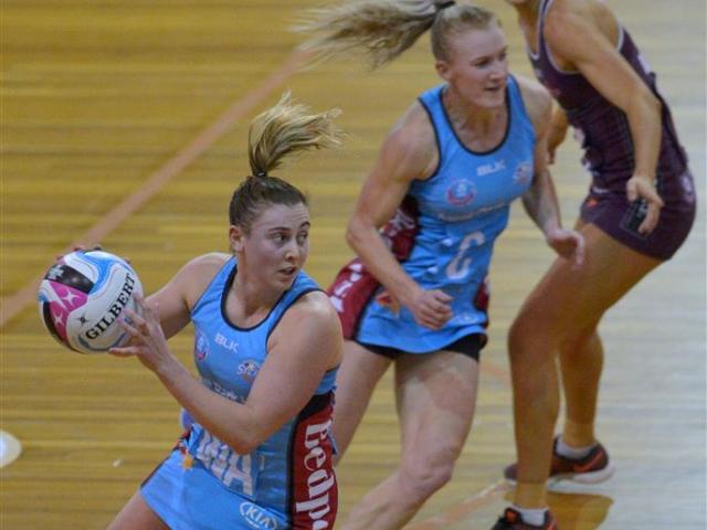 Crampton looks to move the ball on against the Firebirds, as Steel centre Shannon Francis and...