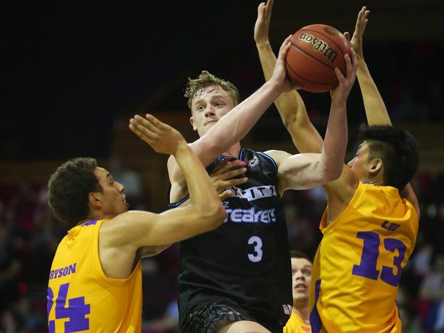 Finn Delany looks to pass for the Breakers against the Sydney Kings in their pre-season...