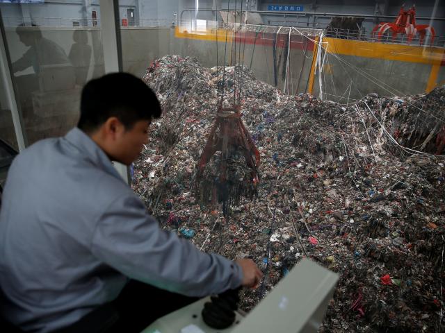 Employees work in the new waste-to-energy plant. Photo: Reuters