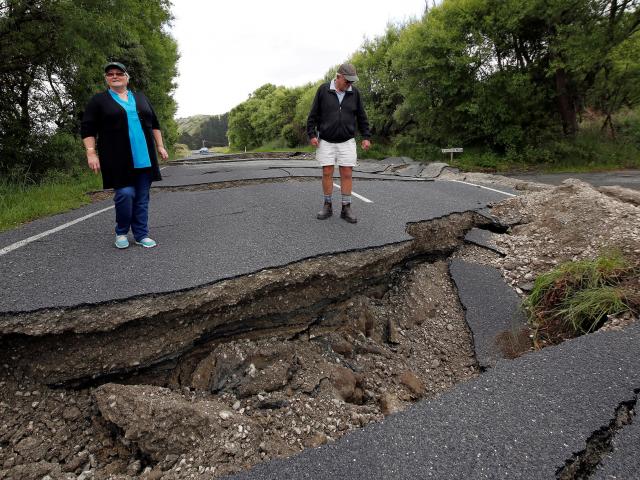 Local residents Chris and Viv Young look at quake damage along State Highway1, south of Blenheim....