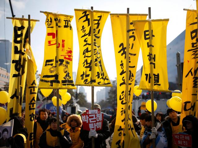 Protesters attend a rally demanding the impeachment of South Korean President Park Geun-hye in...