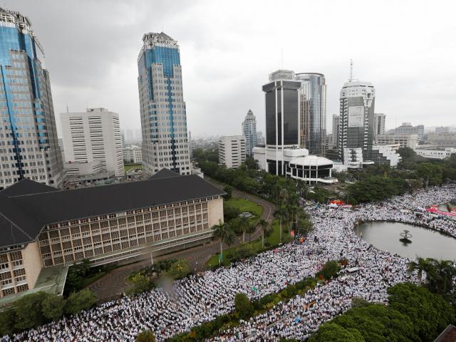 Indonesian Muslims gather in Jakarta to call  for the arrest of Jakarta's Governor Basuki Tjahaja...