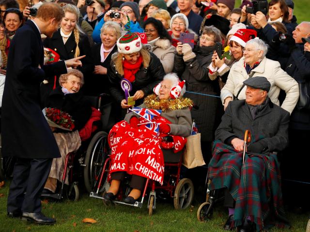 Prince Harry greets well wishers as he leaves the Christmas Day church service in Sandringham....