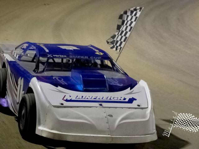 Peter Dickson, of Cromwell, does a victory lap after winning the New Zealand Super Saloons...