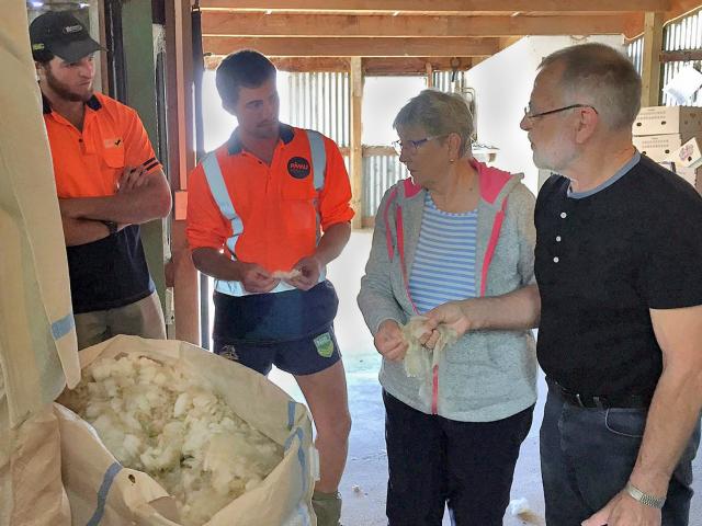Landcorp employees Peter O’Malley (left) and Mace Lee, from Waipori Station, talk wool with Nanny...
