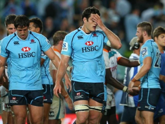 Waratahs captain David Dennis looks dejected after losing the round five Super Rugby match...