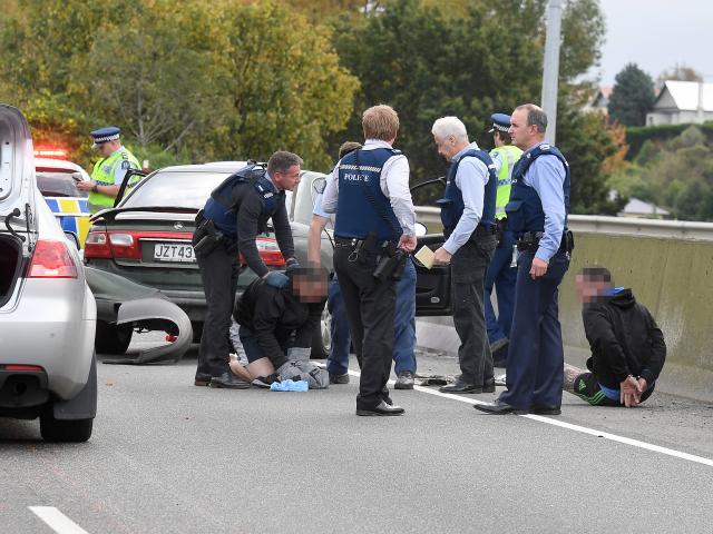 Police arrest three men in Dunedin yesterday after a high-speed pursuit on the Southern Motorway....