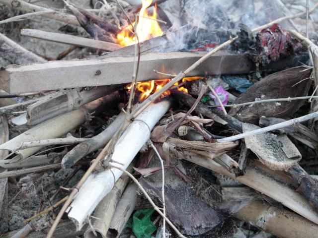 A fire of driftwood and plastic on a Bali beach.