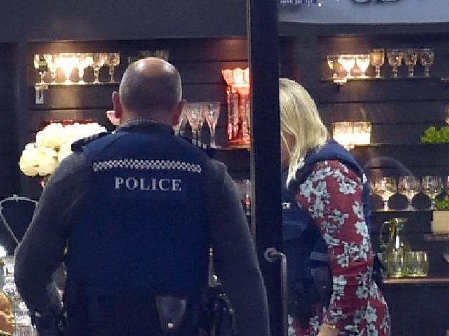 Police at the scene of the robbery at Sue Todd Antiques. Photo ODT