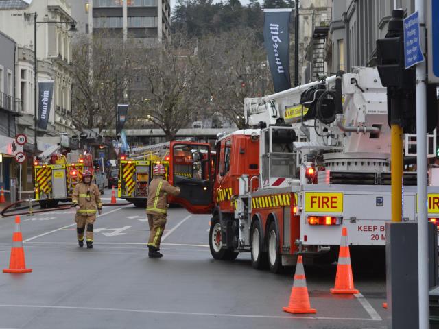 Firefighters work in a cordon in central Dunedin yesterday. Photo: Gerard O'Brien.