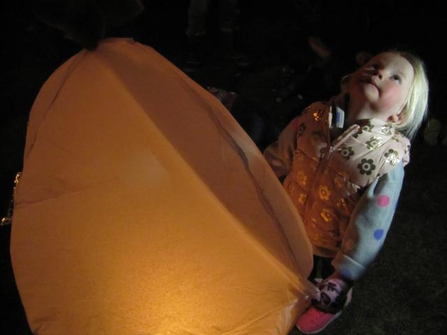 Olivia Gare (3), of Alexandra, watches lanterns released into the sky. 