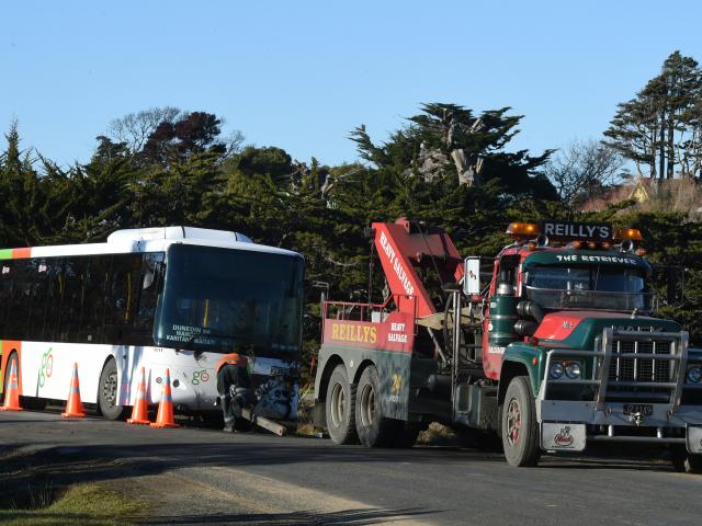 A damaged Go Bus gets towed from Karitane yesterday. Photo: Gregor Richardson.