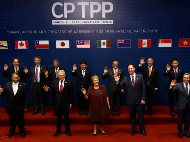 Members of Trans-Pacific Partnership trade deal pose for an official picture before the signing...
