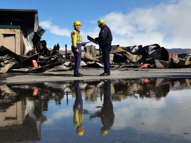 Fire risk management officers Catherine Trevathan and Stuart Ide confer at the scene of the...