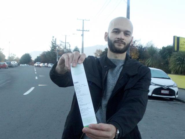 Marco Adreani displays a ticket issued for freedom camping in Queenstown. Photo: Mandy Cooper