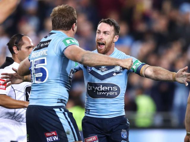 Jake Trbojevic and James Maloney of the Blues celebrate victory after game two of the State of...