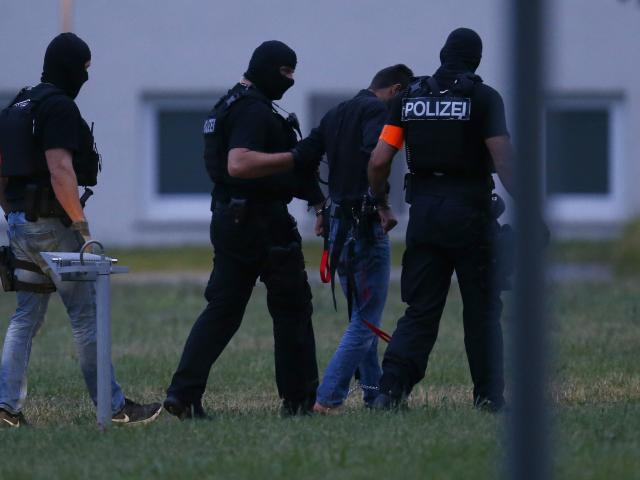Twenty-year-old Iraqi Ali B. is escorted by special police upon his arrival in Wiesbaden. Photo:...
