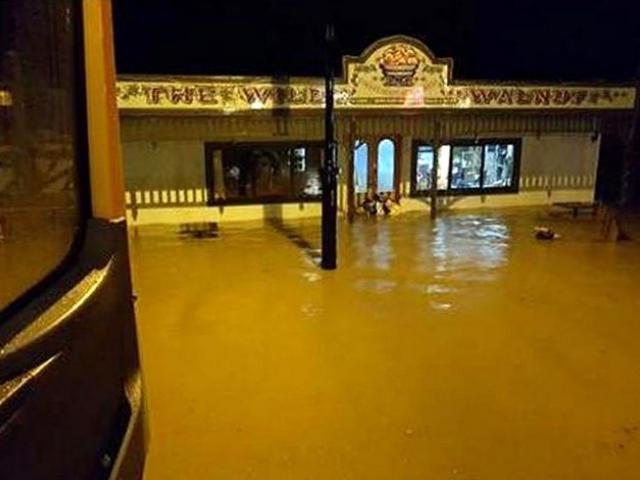 Floodwaters inundate the Wild WAlnut Cafe in Lawrence on the night of June 21, 2017. The town's...
