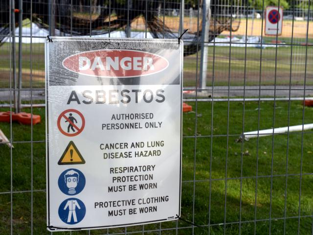 Signs warn the public of the suspected asbestos contamination.