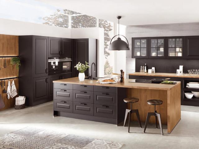 Dark cabinetry offset by natural materials and accessories introduces a country feel to a modern...