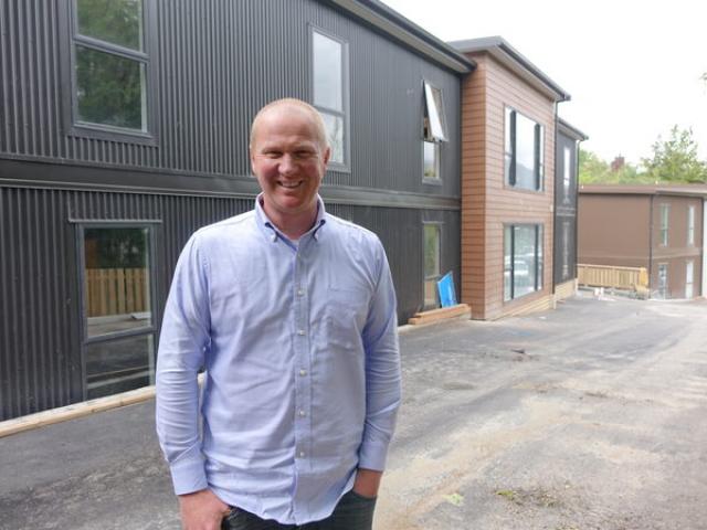 Bus driver and property developer Simon Haslett has helped charity workers move into new...