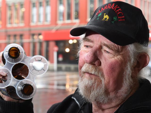 Dunedin resident Ted Young is bewildered about new plastic beer holders edging their way back...