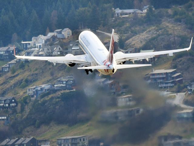 A Virgin Australia aircraft flies over Frankton as it leaves Queenstown  Airport. PHOTO: STEPHEN...