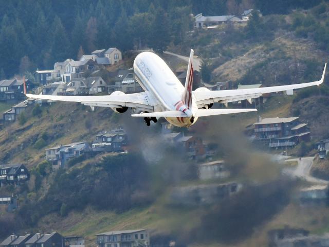 A Virgin Australia aircraft flies over Frankton as it leaves Queenstown Airport. PHOTO: STEPHEN...