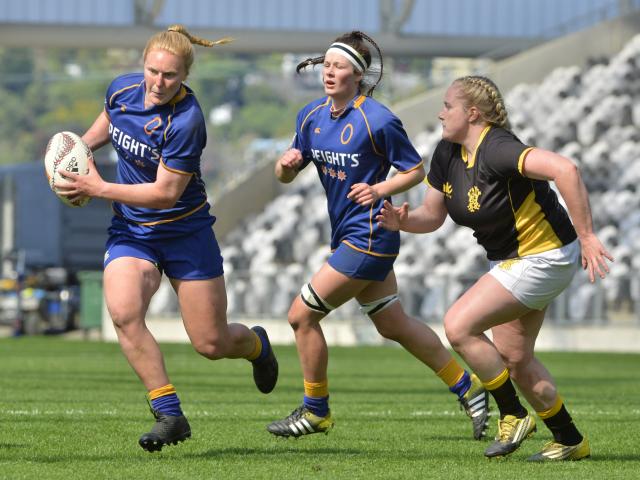 Otago Spirit centre Greer Muir tries to elude Wellington hooker Rosier Stirling while Spirit lock...