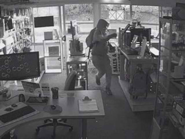 The man enters the store and takes off with two computers. Photo: CCTV