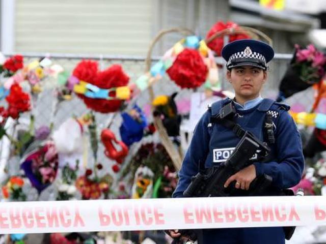 A policewoman stands guard outside the mosque on Linwood Ave after the attacks. Photo: Getty Images