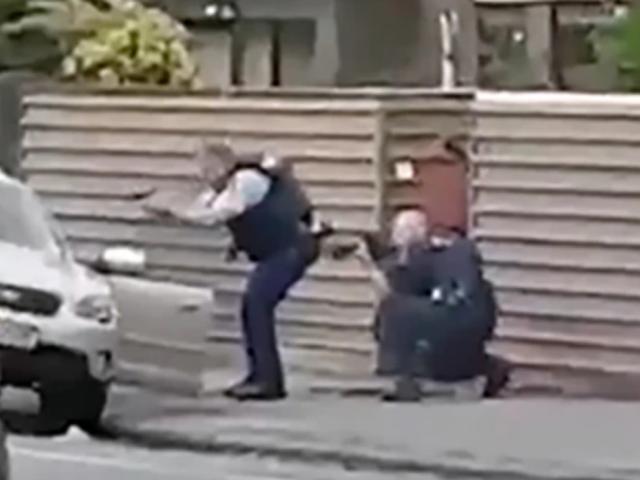 The moment two hero police officers captured the man accused of shooting dead 51 people at two...