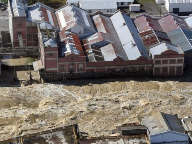 The flooded Mataura River rips past the former Mataura paper mill last week Photo: Stephen Jaquiery