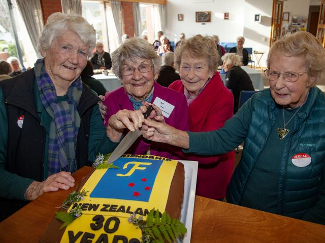 Marie Parry, 94, Pat Dean, 93, Fay Simon, 90, and Robyn Gosset, 89, cut into a special cake to...