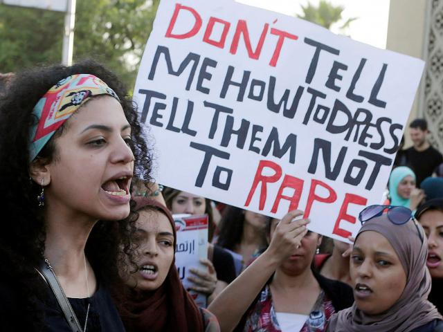 Women chant slogans as they gather to protest against sexual harassment in front of the opera...