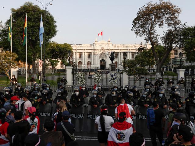 Police stand guard outside Congress after Peru's interim President Manuel Merino announced his...