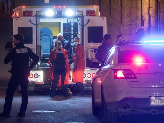 A person is treated by an ambulance crew in an area where multiple people were stabbed in Quebec...