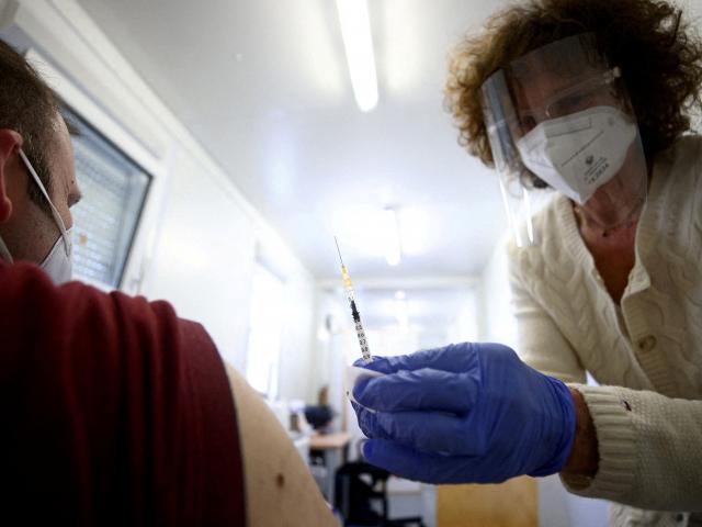 A man gets a Pfizer jab in Vienna.  Roughly 72% of Austria's population is fully vaccinated...