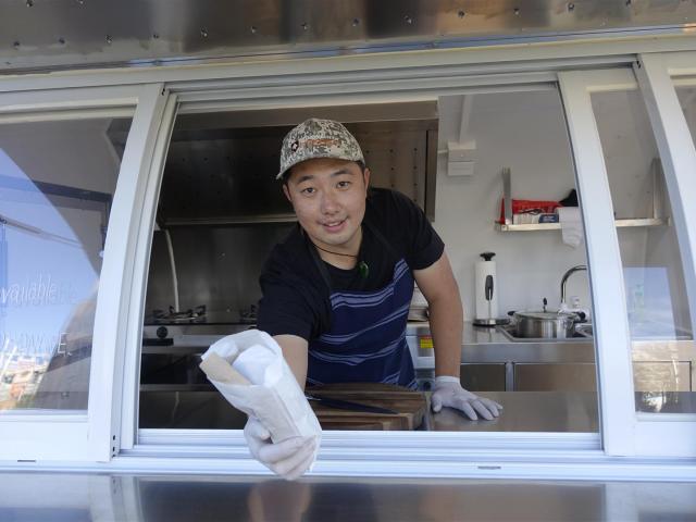 K-Burritos owner Jaeyong Jang serves up a burrito. Photo: Ashburton Courier