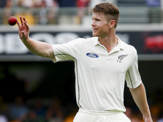 Jimmy Neesham returns to his mark while bowling during New Zealand's first test against Australia...