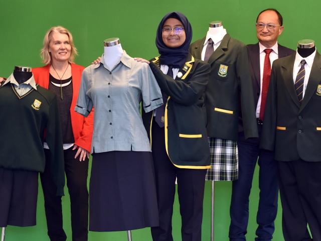 Standing among the uniforms at Bayfield High School as the Human Rights Commission announced new...