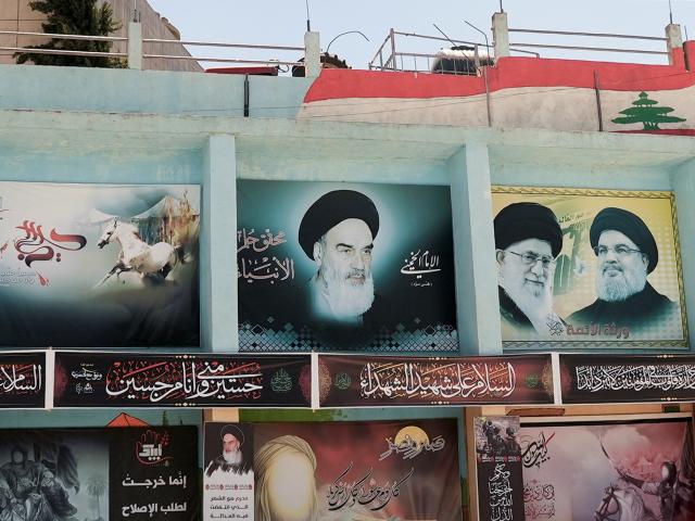 Banners depicting Iran's late leader Ayatollah Ruhollah Khomeini, Iran's Supreme Leader Ayatollah...